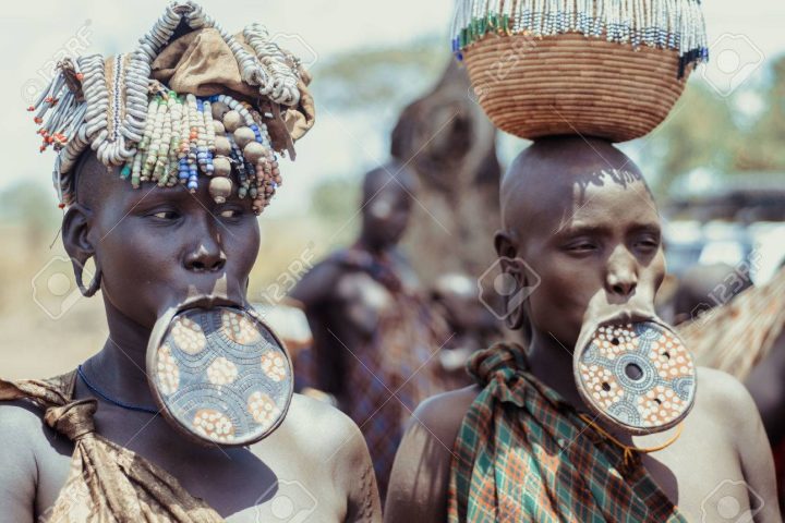JINKA, ETHIOPIA, - 10AUGUST: unidentified women from Mursi tribe with big lip Plate, in Mago National Park, Jinka Ethiopia, on 10 August 2014. In the Mursi tribe, the more the lip plate is big, the more the woman is considered beautiful